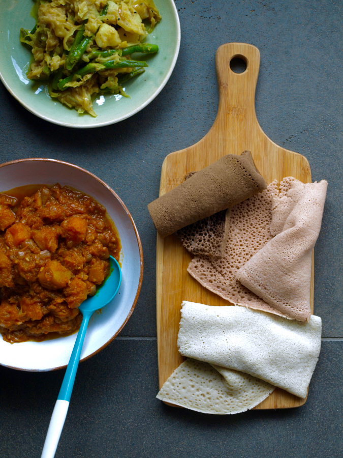 Ethiopian duba wat (berbere pumpkin stew), atakilt (turmeric cabbage with potato and beans), and injera